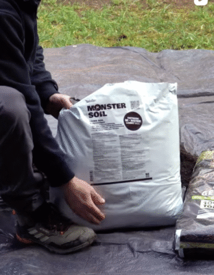 Living soil concentrate: grower holding a bag of Monster Soil Concentrate