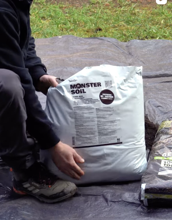 Living soil concentrate: grower holding a bag of Monster Soil Concentrate