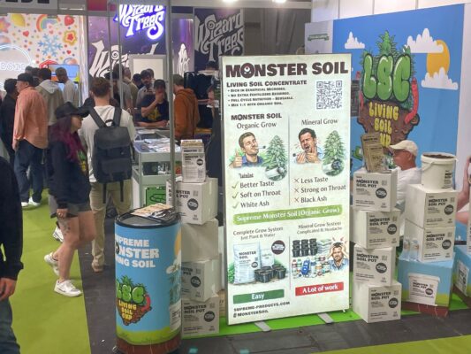 Monster Soil stand with product display and Living Soil Cup banner