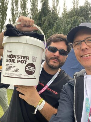Visitor and Monster Soil team member holding a Monster Soil Pot