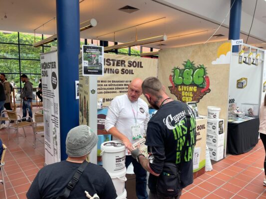 Visitors talking with the Monster Soil team at the stand